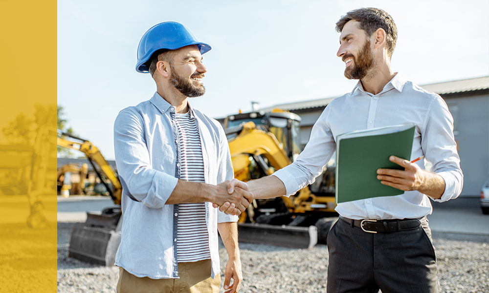 Financial advisor shaking hands with a construction business owner